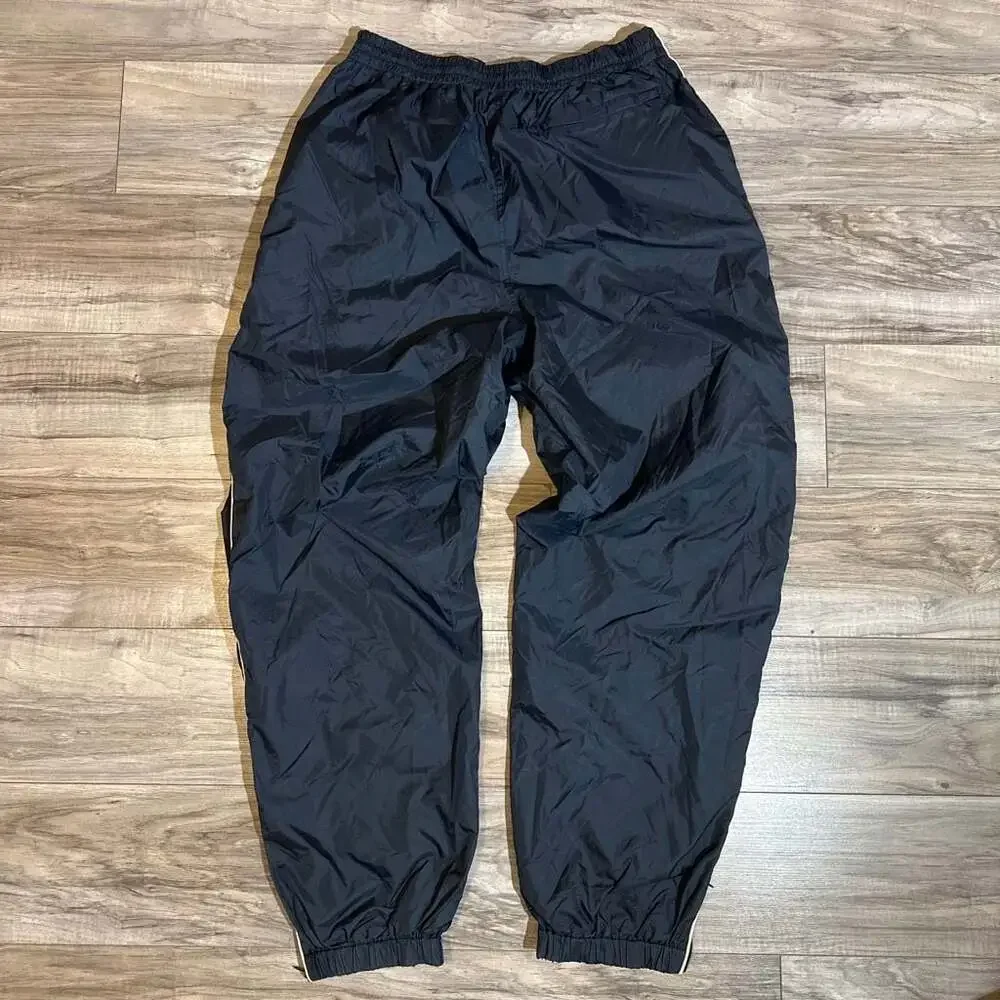 Vintage Men's Navy Blue Nylon Track Pants with White Side Piping and Zip Cuffs
